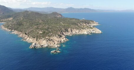 Wall Mural - Sardinia, Italy. Aerial drone view. Slow flight around a rocky cape.