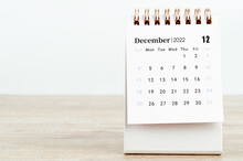 December 2022 Desk Calendar On Wooden Background.