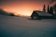 Beautiful Shot Of A Ski Lodge On The Crest Of The Mountain With A Background Of Sunset.