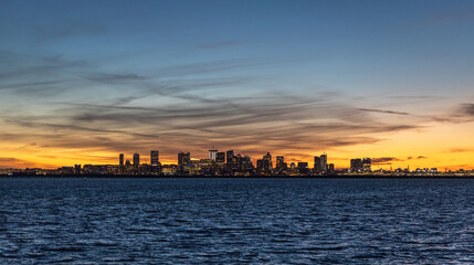 Poster - Boston skyline along the harbor against dusk sky across the Atlantic ocean, Massachusetts, USA