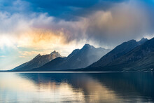 Reflective Lake And Rocky Mountains In Grand Teton National Park Under The Gloomy Sky In Wyoming