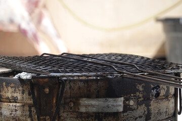 Closeup of an old dirty iron material net on an old worn container