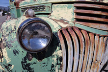 Closeup Shot Of An Old Weathered Truck Headlight With Oxidized Grill And Paint Swirls