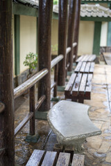 Sticker - Vertical shot of stone and wooden benches in a backyard