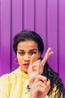 © Dani D.G - Black woman gesturing near wall