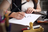 Fototapeta  - Calligraphy, woman writes with a fountain pen.