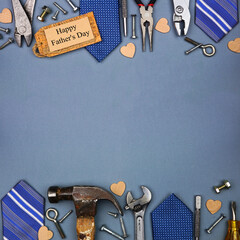 Poster - Happy Fathers Day gift tag with double border of ties and tools on a square blue grey paper background. Top down view with copy space.