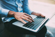 © BullRun - Crop man using laptop in modern workplace