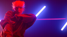 Girl Hiphop Dancer Moving Body Emotionally In Ultraviolet Backlit Close Up. 