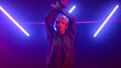 © stockbusters - Professional dancer girl moving hands energetic in ultraviolet lights close up.