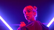 © stockbusters - Girl making modern hiphop moves in neon lights. Artistic woman dancing freestyle