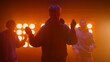 © stockbusters - Dancing band performing street style in spotlight. Cool team moving rhythmic.