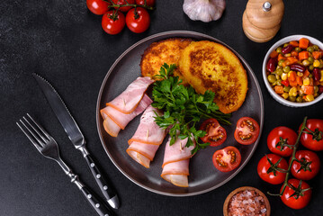 Slices of delicious raw or salted bacon with spices, salt, vegetables and herbs on a wooden cutting board