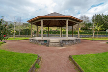 Wooden Gazebo With Concrete Floor Under Slate Roof In Park