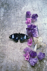 Wall Mural - black butterfly and quartz minerals on abstract dark background. Amethyst gemstones for relaxation, meditation. Esoteric, spiritual practice, witchcraft ritual for positive spirit, harmony. top view