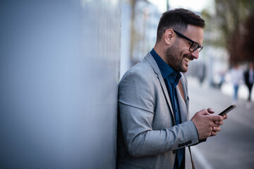 Wall Mural - Young manager is texting message on cell phone