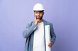 © luismolinero - Young architect Moroccan man with helmet and holding blueprints over isolated background having doubts and thinking