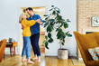 © baranq - Mid adult couple having fun dancing together at home