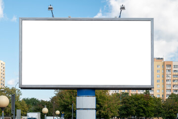 Wall Mural - Blank white advertising billboard near residential buildings in the city on a sunny summer day.