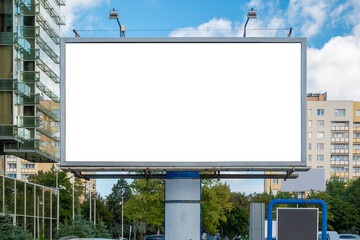 Wall Mural - Blank white advertising billboard near residential buildings in the city on a sunny summer day.