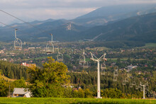 View Of Chairlift In Tatra Mountains, Poland. There Are Zakopane City And Mountain Peaks In The Background.