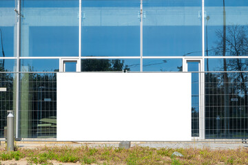 Blank white banner for advertisement on the fence of construction site