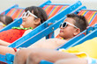 Group of Smiling diversity little child boy and girl in swimwear lying on beach chair together on tropical beach on summer vacation. Happy children kid enjoy and fun outdoor lifestyle on beach holiday