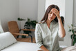 © Oleksandr - Young woman with headache in home interior