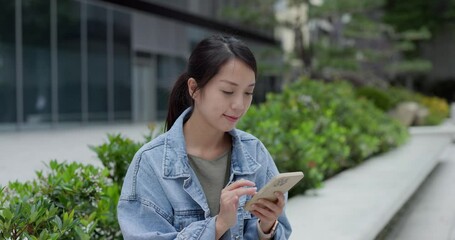 Wall Mural - Woman look at mobile phone in city