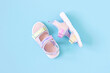 Stylish holographic sandals for kids on blue background. Shiny fashion summer shoes. Flat lay, Top view