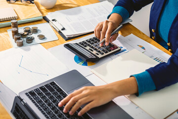 Poster - accounting concept. businesswoman working using calculator with money stack in office