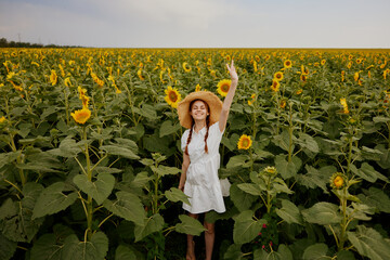 Wall Mural - beautiful sweet girl looking in the sunflower field Summer time