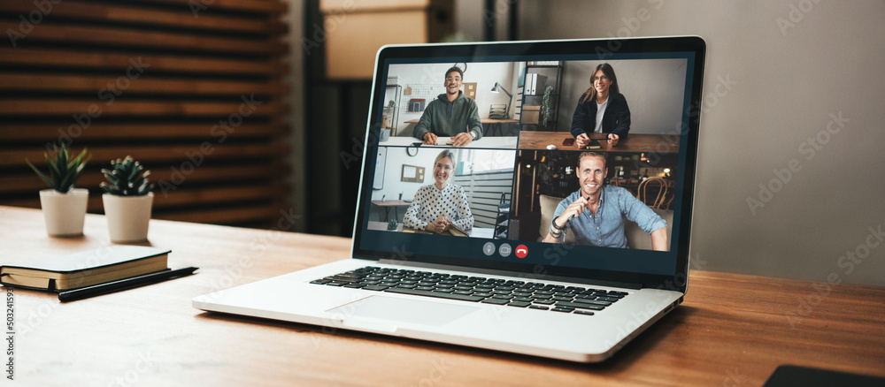 Video call conference on s laptop screen at cozy loft style place ...