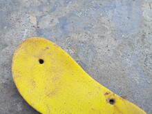 Ugly Yellow Sandals And Abandoned On The Ground
