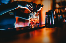 Woman Bartender Hand Making Cocktail In Nightclub