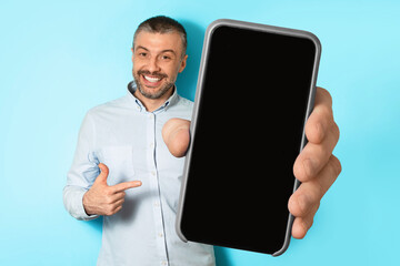 Poster - Middle Aged Man Showing Phone Blank Screen Over Blue Background