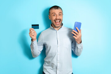 Poster - Man Holding Cellphone And Credit Card Shopping Online, Blue Background