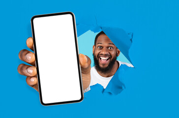 Poster - Excited guy showing white empty smartphone screen through torn paper
