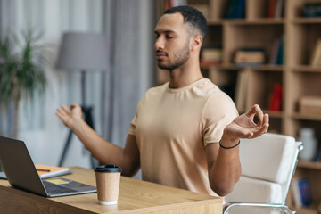 Poster - Stress relief at job concept. Calm arab man meditating in front of laptop at home, sitting at workplace