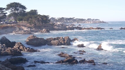 Wall Mural - Rocky craggy ocean beach, big sea waves crashing on shore, Monterey 17-mile drive, California coast, USA. Water splashing in beachfront waterfront Pacific Grove, seascape, seamless looped cinemagraph.