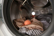 Dryer ball and clothes in washing machine, closeup