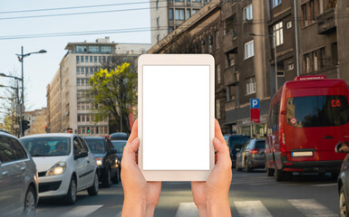 Wall Mural - person holding a tablet pc in the city