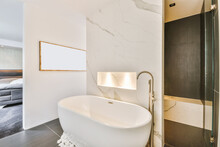 Modern Bathroom With White Bathtub Surrounded With White Stones