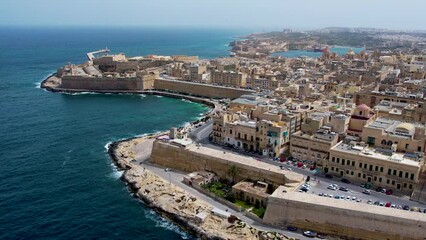 Wall Mural - Aerial 4K footage of a drone flight over of Basilica Lady of Mount Carmel church, St. Paul's Cathedral in the old town of Valetta, Malta. Roofs of Malta capital from above on a sunny day