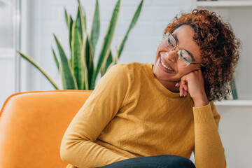 girl smiling happy at home sitting on the sofa