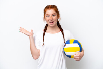 Young caucasian reddish woman playing volleyball isolated on white background with shocked facial expression