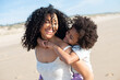 © KAMPUS - Tender mother and daughter spending time on beach. African American family walking, laughing, playing, riding on back. Leisure, family time, parenthood concept