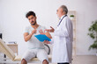 © Elnur - Young male patient visiting old male doctor
