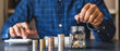 © crizzystudio - Businessman holding coins putting in glass. concept of saving money for finance accounting, for saving money wealth, Savings for Retirement Planning
