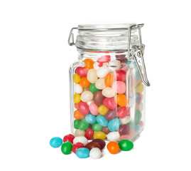 Wall Mural - Glass jar with multicolored jelly beans on white background